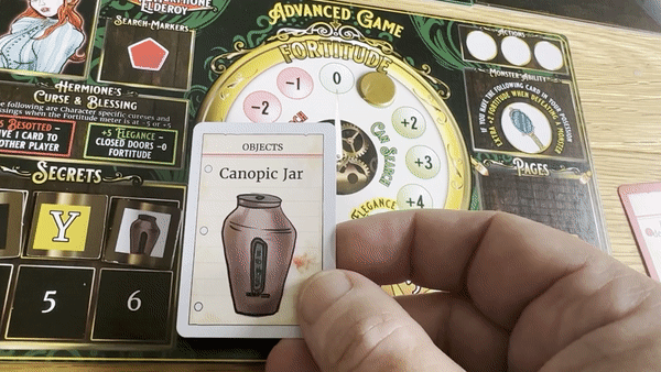 A player revealing a card while searching for secrets and pages