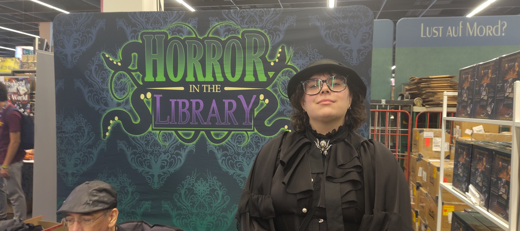 Horror in the Library booth display with branded backdrop at a convention